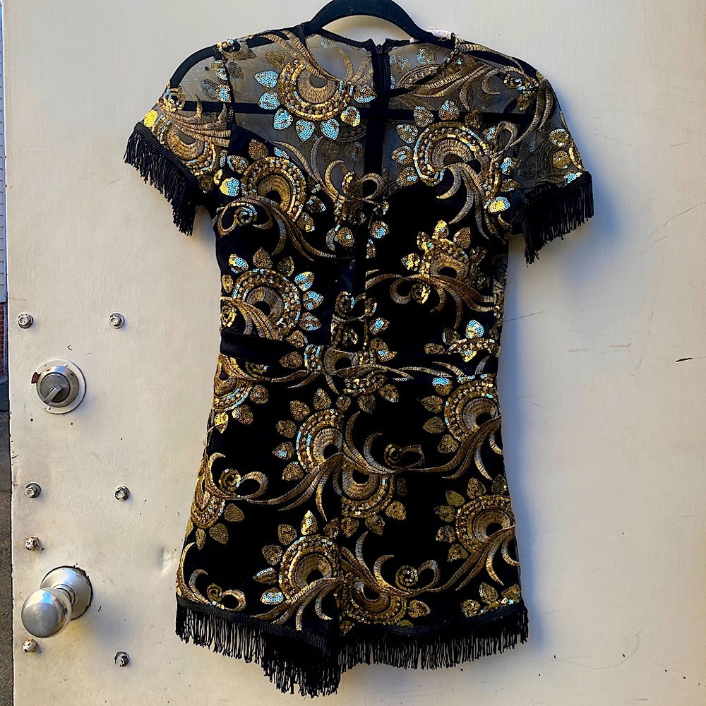 Embellished party romper. A cute combination of fringe, mesh, and sequins